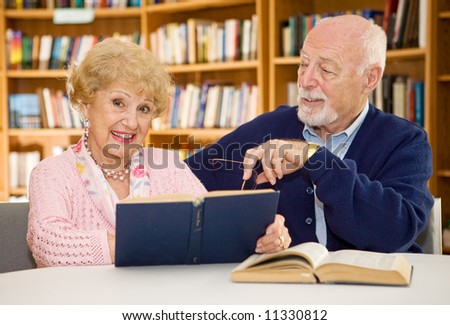 Senior lady happy because she met the man of her dreams in the library.  Focus on the woman.