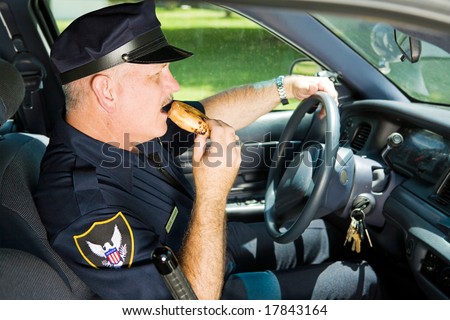 stock-photo-police-officer-snacking-on-a-donut-while-sitting-in-his-squad-car-17843164.jpg