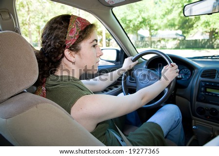 Teen driver looking both ways before pulling into the intersection.