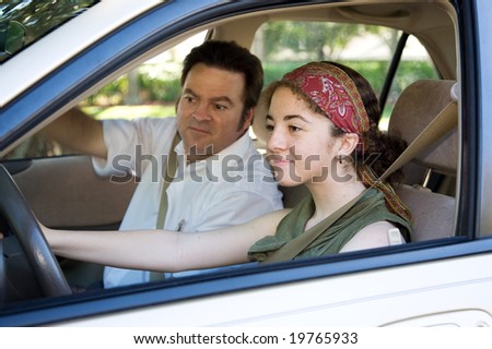 Teen learning to drive or taking driving test.