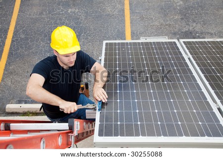 Electrician repairing solar panel.  Wide angle view with room for text.