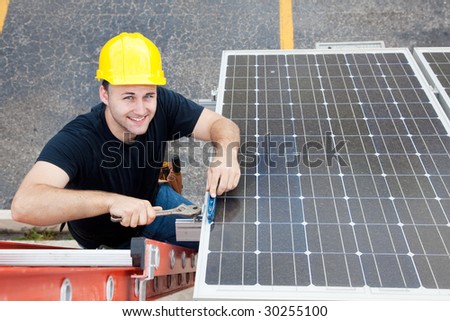 Electrician installing solar panels on the roof of a building.