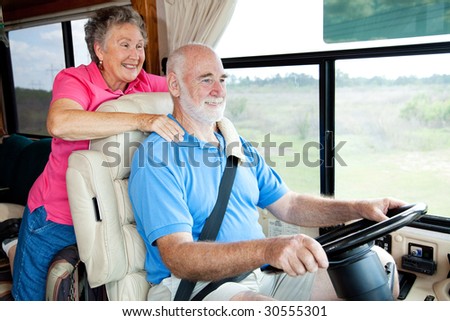 Senior couple traveling in their motor home. The husband is driving.