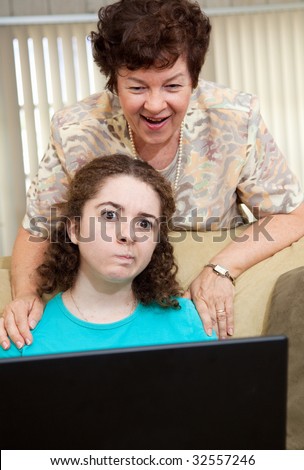 Teen girl annoyed by her aunt watching her work on the computer.