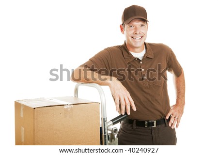 Handsome delivery man leaning on his dolly filled with boxes.  Isolated on white.
