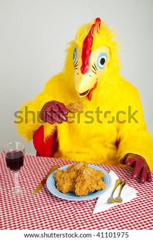 Chicken man sitting down to a fried chicken dinner.  Disgusting!