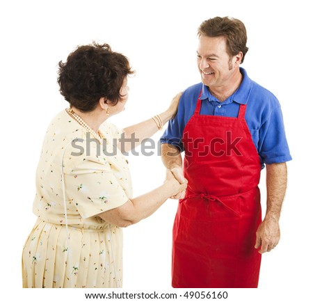 Female store owner congratulates one of her sales clerks.  Isolated on white.