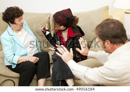 Teen girl yelling at her mother during a family counseling session.