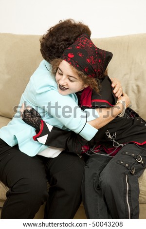 Goth teen girl gives her mother a hug.  (bandana is generic, not brand name or trademarked)