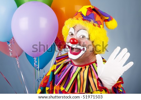 Happy clown with helium balloons, waving hello.