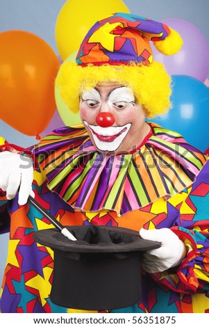 Birthday clown performing a magic act with a tophat and wand.