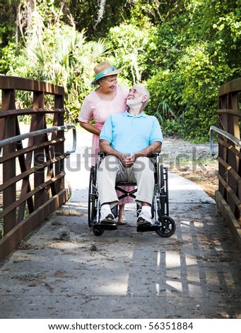 Devoted senior wife cares for her disabled husband.