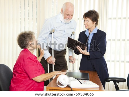 Injured man and his wife meet with a personal injury lawyer.