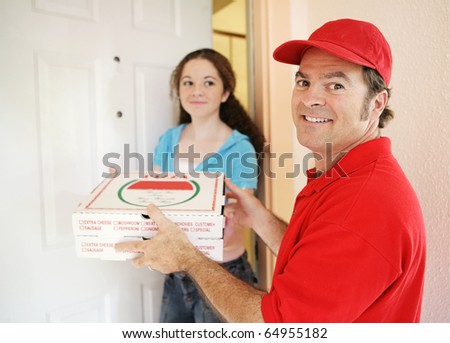 Friendly delivery man handing pizza to a customer.