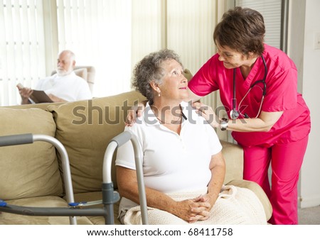 Senior woman in a nursing home, with a caring nurse.
