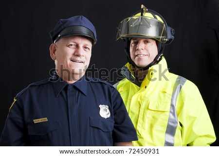 Public employees, a firefighter and a police officer, smiling and happy.  Black background.