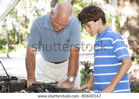 Father and son working together on the car engine.