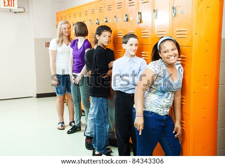 Diverse group of teenage students at their school lockers between classes.
