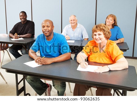 Diverse adult education class, various ages and ethnicities, smiling and happy.