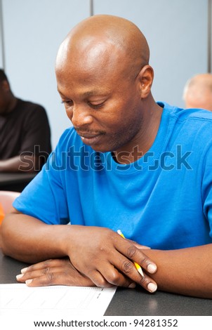 Handsome African-american college student taking a test.