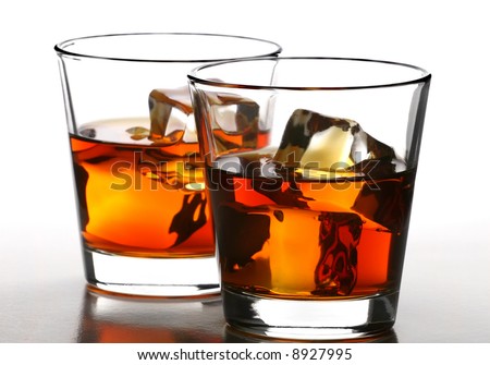 two glass of whiskey with ice cubes on white background