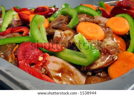 Stir fry raw chicken mixture with bright fresh vegetables
