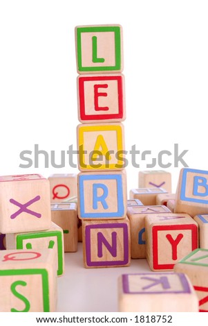 Children\'s colored blocks spelling the work learning and surrounded by other blocks - has clipping path