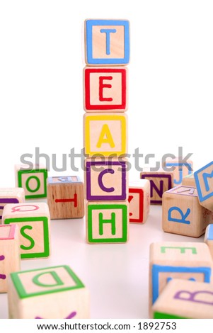Children\'s colored blocks spelling the word teach and surrounded by other blocks - has clipping path