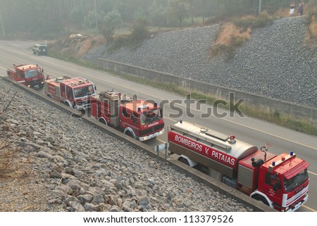 POMBAL, PORTUGAL - JULY 15: Fire Trucks on a road to prevent that wildfire crosses the road, in Pombal, Portugal on July 15, 2012