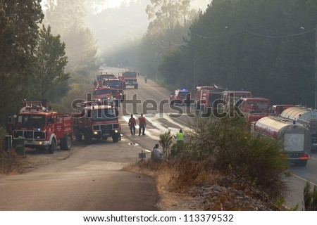 POMBAL, PORTUGAL - JULY 15: Fire Trucks on a road to prevent that wildfire crosses the road, in Pombal, Portugal on July 15, 2012