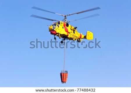 PENELA, PORTUGAL - AUGUST 28 : Fire rescue heavy helicopter, with water bucket, preparing for water scooping for combat a fire in Penela August 28, 2010 in Penela, Portugal