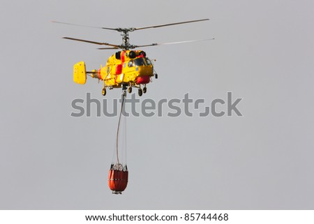 POMBAL, PORTUGAL - OCTOBER 1 : Fire rescue heavy helicopter with water bucket, goes to a fire in Pombal on October 1, 2011 in Pombal, Portugal.