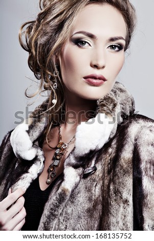 Beautiful elegant woman in a fur coat