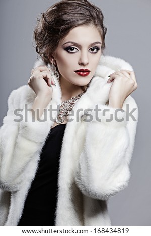 Beautiful elegant woman in a fur coat