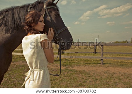 beautiful girl in a white gown with horse on nature