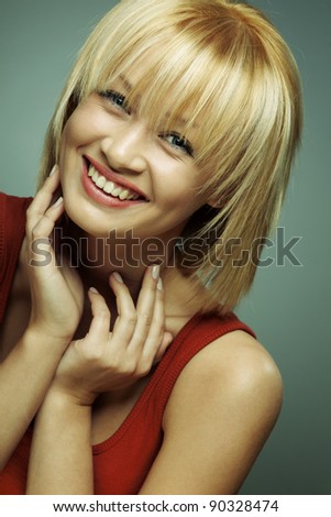 portrait of beautiful smiling girl with perfect skin on a dark background