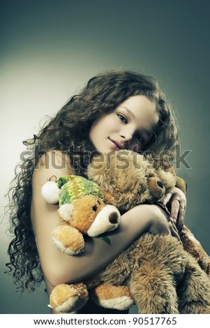 Beautiful girl smiling holding a gift - toys