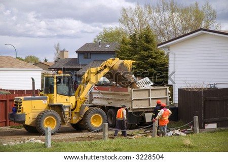 City workers cleaning up residential refuse.