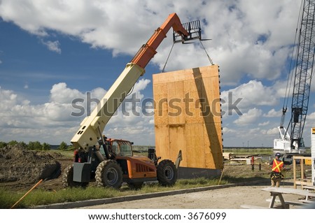 Wall being moved by a Boom lift.