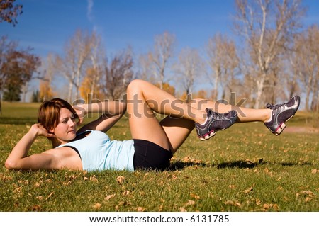 Young woman doing a bicycle ab exercise.