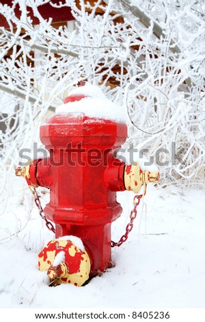 A red fire hydrant with peeling paint, in the snow.