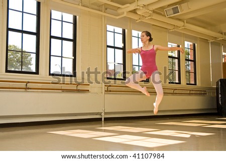 Young ballerina practicing in a dance studio.