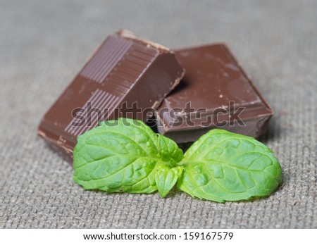 stack of chocolate pieces with a leaf of mint