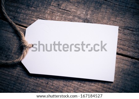 Close up of a note and a clothes peg on grunge wooden background with clipping path