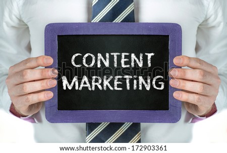 Content Marketing. Business man holding board on the background with business word
