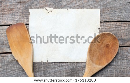 Old recipe notebook, spoons on wood background