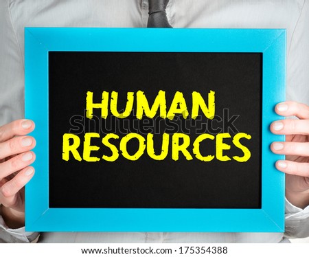 Human resources. Business man holding board on the background with business word.