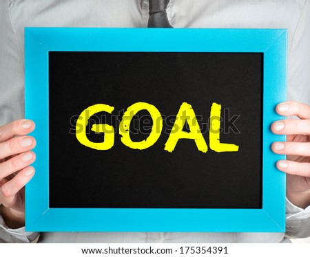 Goal. Man holding blackboard with word Goal