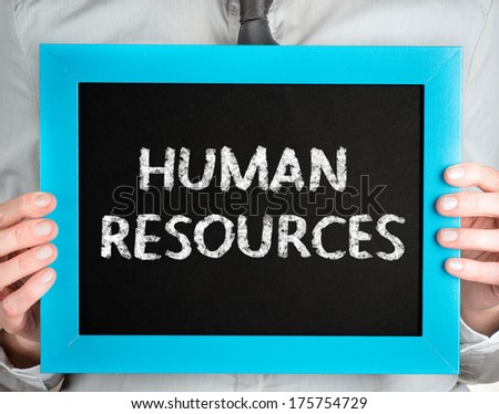 Human Resources. Business woman holding board on the background with business word