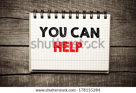 You can help written on white paper on wooden background , texture